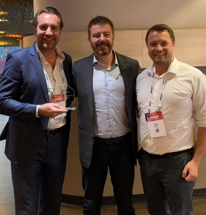 The Roboyo team receiving the UiPath award on stage at UiPath Fusion